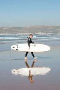 Beginner surf Morocco beach practice pop-up technique sand demonstration ISA instructor before ocean entry