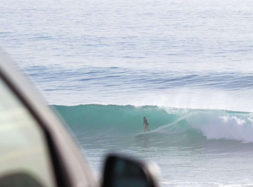 Intermediate surfer riding green wave Banana Beach point break Morocco surf package
