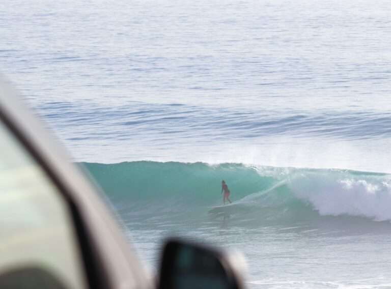 Intermediate surfer riding green wave Banana Beach point break Morocco surf package
