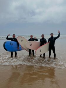 Group of surfers walking to the sea with their surfboards