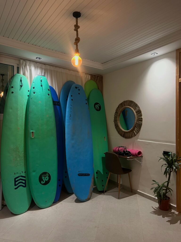 Green soft-top surfboards lined up in the Endless Wave surf house