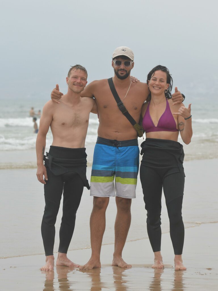 Smiling surf camp guests on the beach in Tamraght