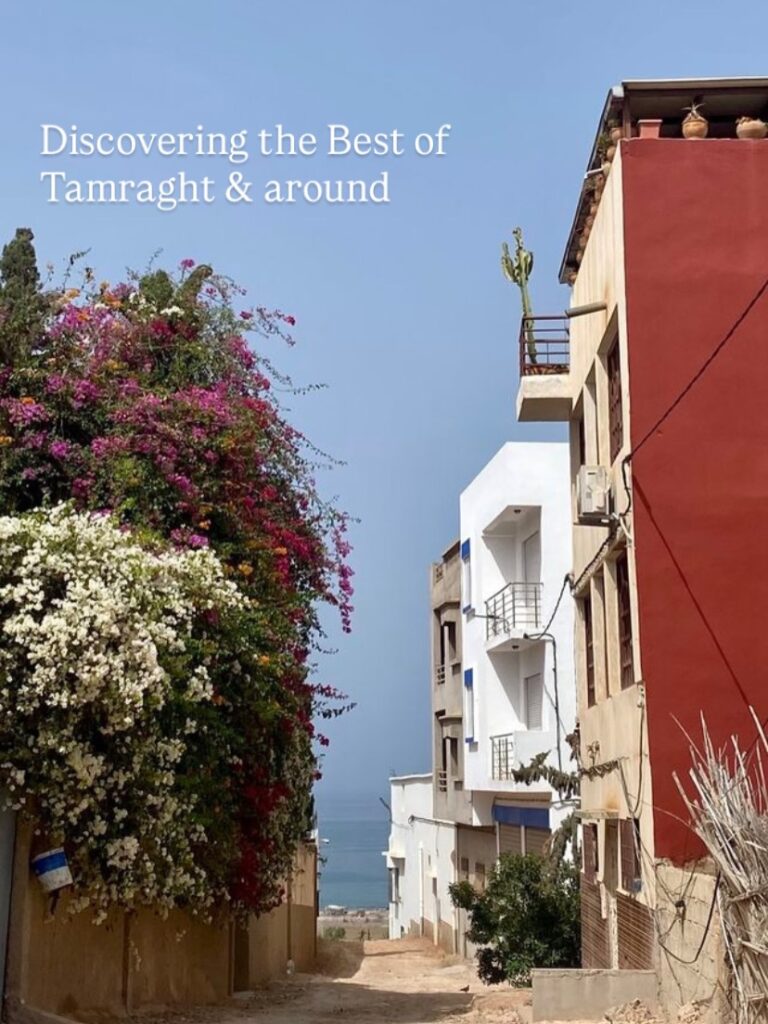 Bougainvillea flowers and white houses in a village street near Tamraght