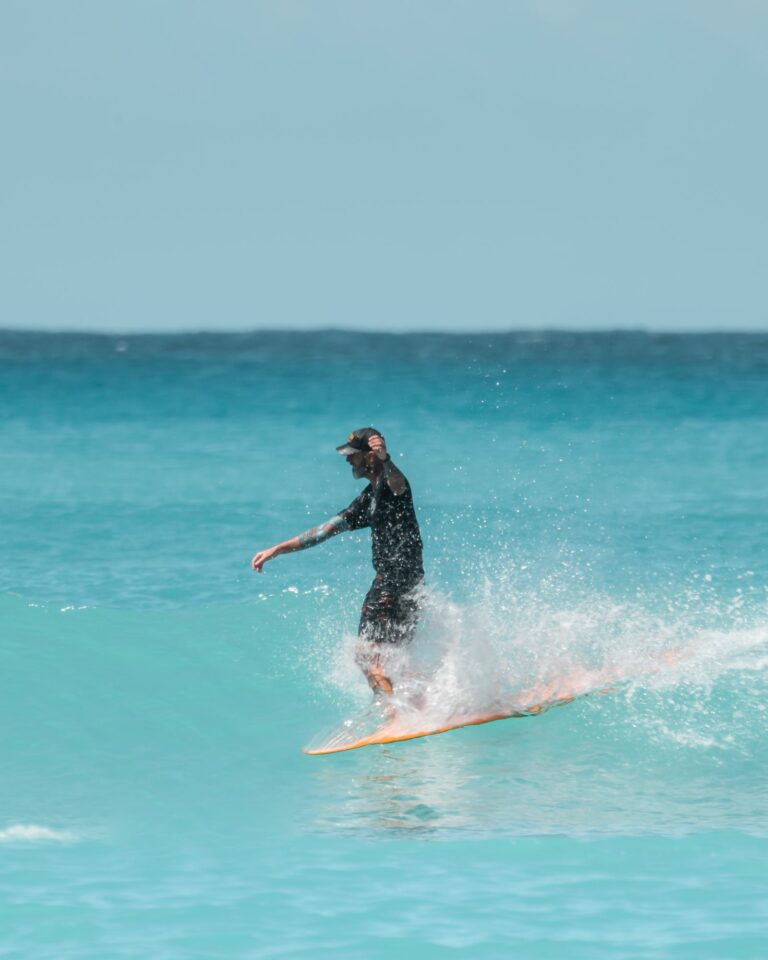 Surfer in a black wetsuit riding a wave