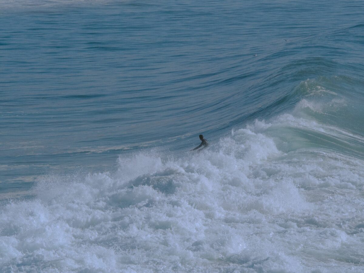 Surfer riding a wave in Taghazout, Morocco