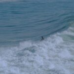 Surfer riding a wave in Taghazout, Morocco